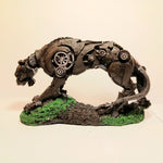 Mechanical panther figurine with gears on a green base against a beige background